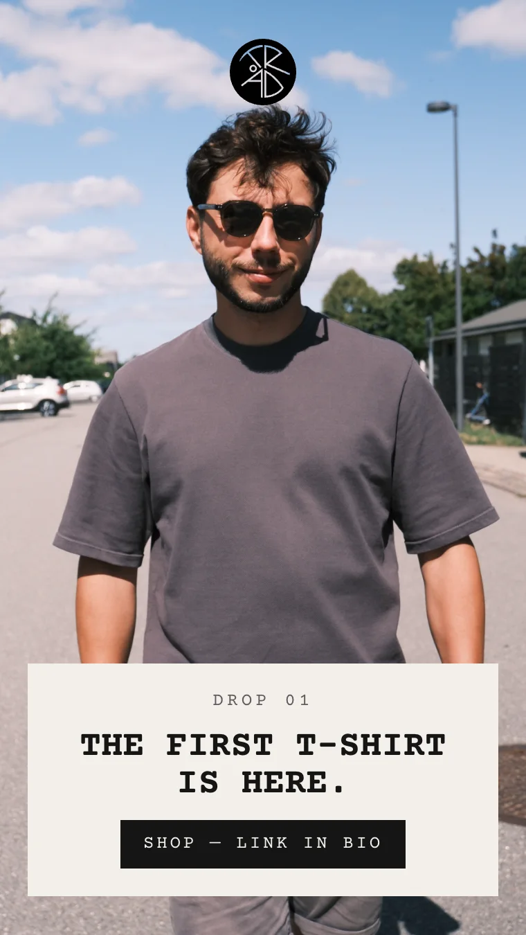 Instagram story: a man in the ash T-shirt on a sunny street — “Drop 01. The first T-shirt is here. Shop — link in bio”